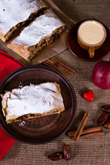 Apple strudel, apple pie, a cup of coffee  and heart. The atmosphere for a cozy romantic evening.