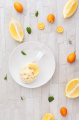 Citrus fruit mousse. Homemade lemon almond mousse with candied kumquats peel. 