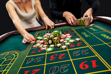 Couple playing roulette wins at the casino.