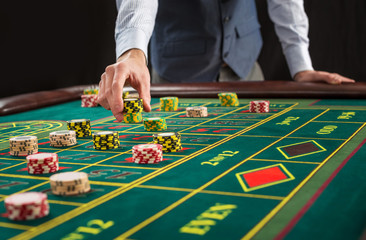 Picture of a green table and betting with chips.