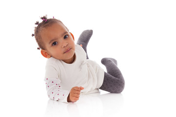 Portrait of little African American little girl lying down on th