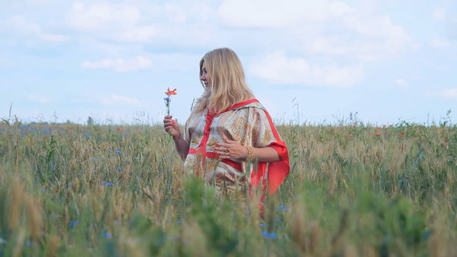 Pregnant woman walking in a field. Caucasian woman.  Female, miss, lady.Protection of the environment and ecology. Natural resources of the Earth. 