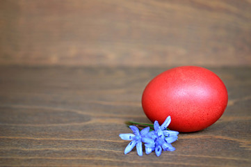 Red Easter egg on wooden background