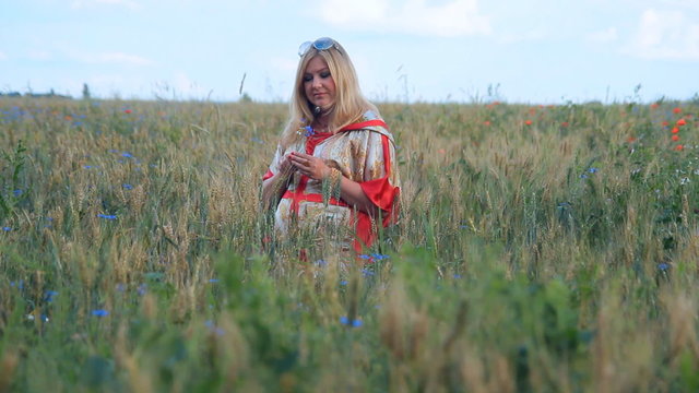 Pregnant woman walking in a field. Caucasian woman.  Female, miss, lady. Environment and ecology.