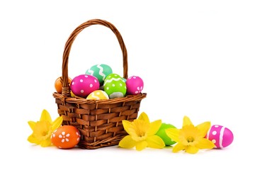 Fototapeta na wymiar Easter basket with colorful eggs and daffodils on a white background
