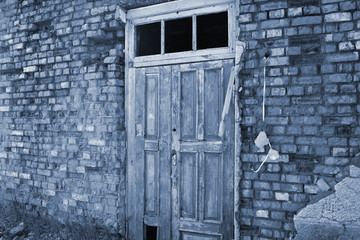 Old door on a dilapidated wall