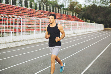 Fototapeta na wymiar Man running on a racing track