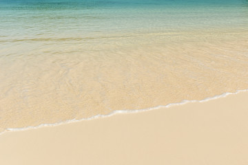 Fototapeta na wymiar Beautiful sand beach and tropical turquoise blue sea.