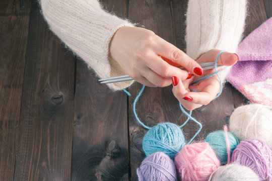 woman hands knitting with stylish knitting needles