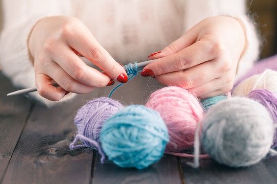 woman's hand knitting scarf, handcraft.