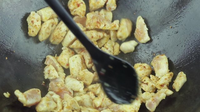 cooking chicken curry with fried vegetables