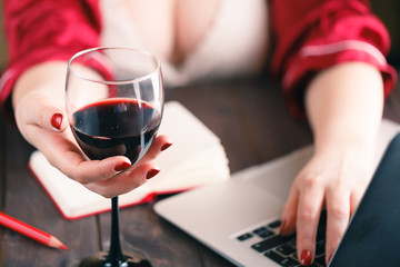 Woman using laptop and having a drink