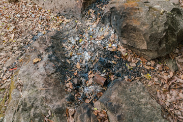 Waste Incineration - dark ash and rest of burned waste such as daily used waste as human made surrounding pollution 
