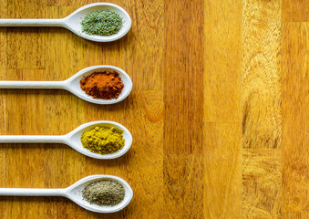 Collection of various food ingredients in wooden spoons