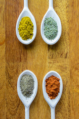 Collection of various food ingredients in wooden spoons