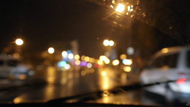 Bad Weather, Rain And Wet Snow On The Road. Night Driving, The Road In The Headlights Of A Car Window, Rain Drops And Wet Snow On The Windshield. Bokeh And Glare, Reflection Night Lights.