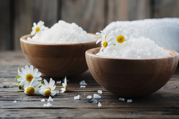 Concept of spa treatment with salt and daisy