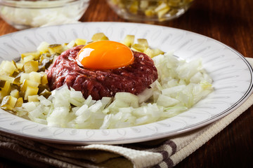 Steak tartare with egg yolk, onions and pickles
