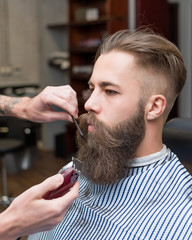 Handsome man with a long mustache in barbershop