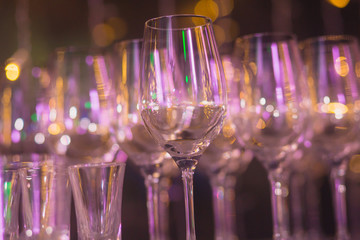 Beautiful row line of different colored alcohol cocktails with mint on a christmas party, martini, vodka,and others on decorated catering bouquet table on open air event, picture with beautiful bokeh