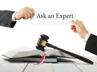 Law book and wooden judges gavel on table in a courtroom or law enforcement office. Lawyer Hands...