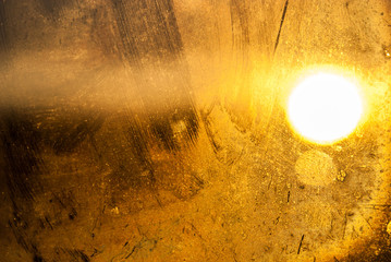 Generic use background.  Sun shines through an old dirty and streaked pane of glass still in its original frame.