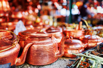 Fototapeta na wymiar Vintage copper tea kettles at market in Lijiang, China