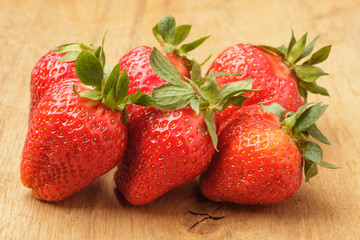 Red fresh strawberry fruits on wooden table.
