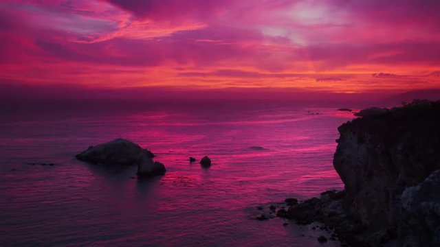 Colorful sunset over ocean cliffs rainbow sky in Pismo Beach, California