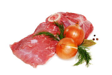 raw pork meat on the bone with onion and herbs isolated against white background