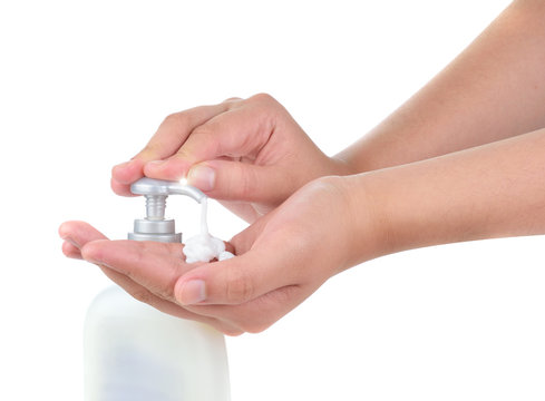 woman applying cream on hands on white background