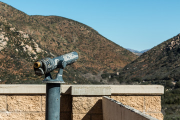 Sightseeing binoculars facing mountain range at lookout in San Diego, California.