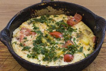 Frittata (italian omelet) with cherry tomatoes and spinach in pa