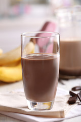 Glass of chocolate milk on table close-up
