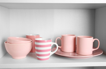 Tableware on shelf in the kitchen cupboard