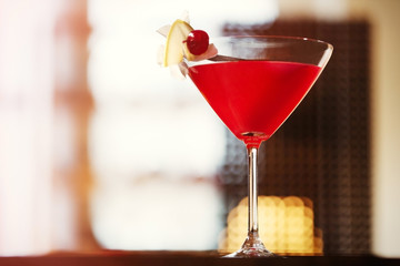 Glass of cocktail on bar background