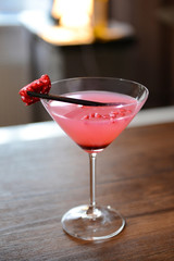 Glass of cocktail on bar background