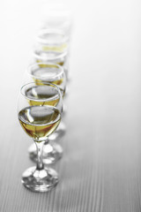 Row of wineglasses on wooden blurred background