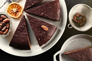 Pieces of frosting chocolate cake on black table