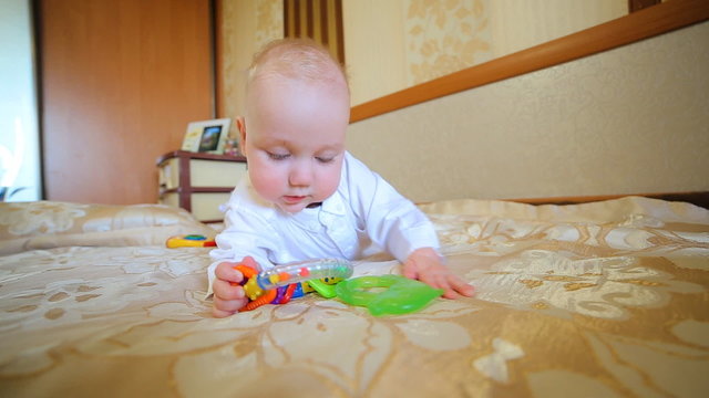 Caucasian child, little active cute baby boy kid toddler playing toys