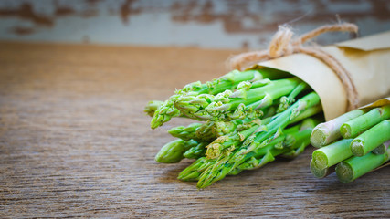 Bunch of fresh asparagus on wooden table
