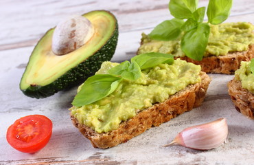 Freshly sandwiches with paste of avocado and ingredients, healthy food and nutrition