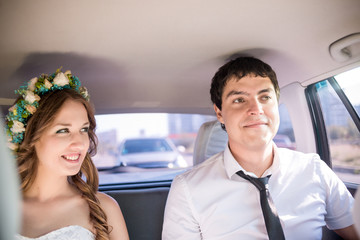 dride and groom in the car