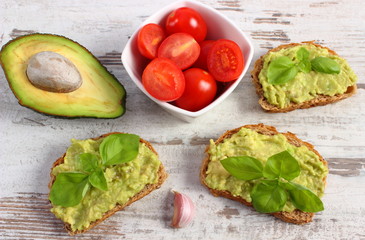 Freshly sandwiches with paste of avocado and ingredients, healthy food and nutrition