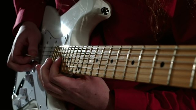 Playing guitar solo on white guitar