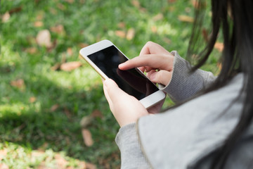 Shopping online anywhere anytime / Woman use mobile phone in garden on sunny day do shopping online