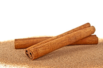 Cinnamon sticks with powder isolated on white background