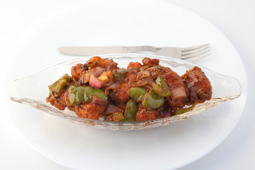 Indian food or Chinese food. Chicken with sweet and sour sauce.