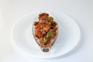 Indian food or Chinese food. Chicken with sweet and sour sauce.