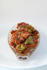 Indian food or Chinese food. Chicken with sweet and sour sauce.